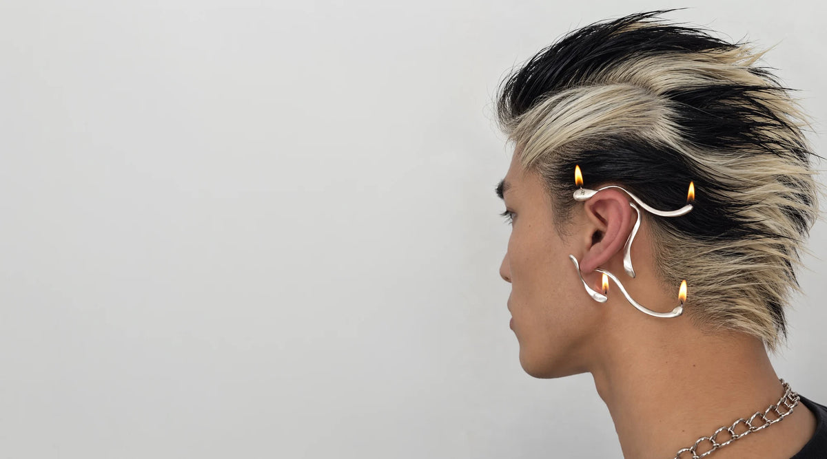 The Whisper Ear Cuff worn with its four tips lit like birthday candles